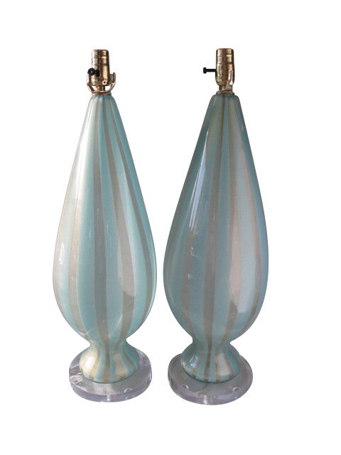 A stunning pair of urn-shaped Murano glass lamps in crystal and turquoise stripe ("sticks") with 24k gold flecks and set on circular acrylic bases. From the now-closed Barbini Factory in Murano, Italy, circa 1955. Perfect for the vintage glass collector or an individual looking to achieve that luxurious, high-end look in their home.