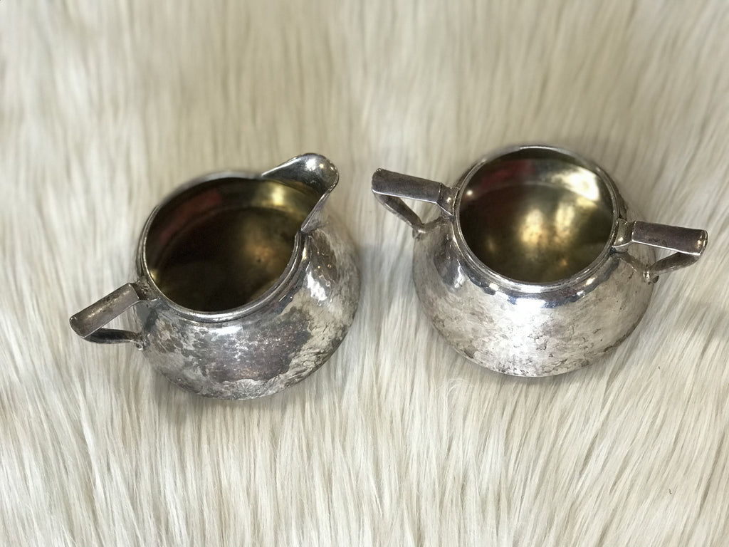 An antique set of Forbes Silver Co. silver-plated, hammered finish sugar bowl and creamer circa 1895.